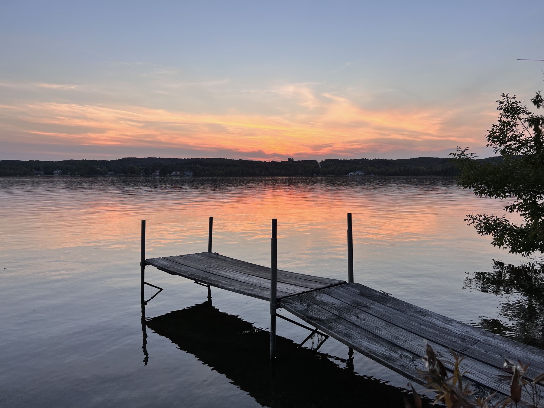 Lake with dock at sunset